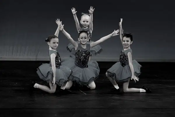 4 girls in final position on stage dancing